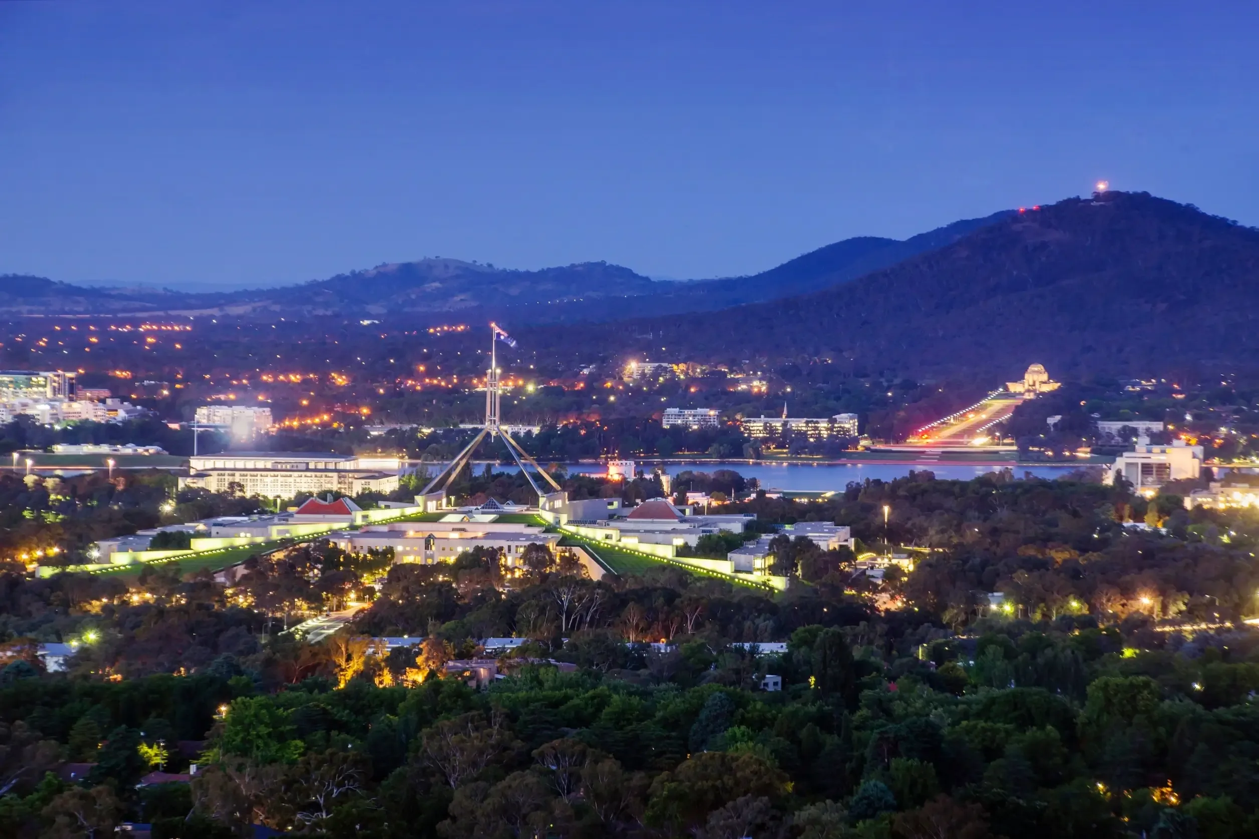 Night view of Parliament House and the Canberra city skyline