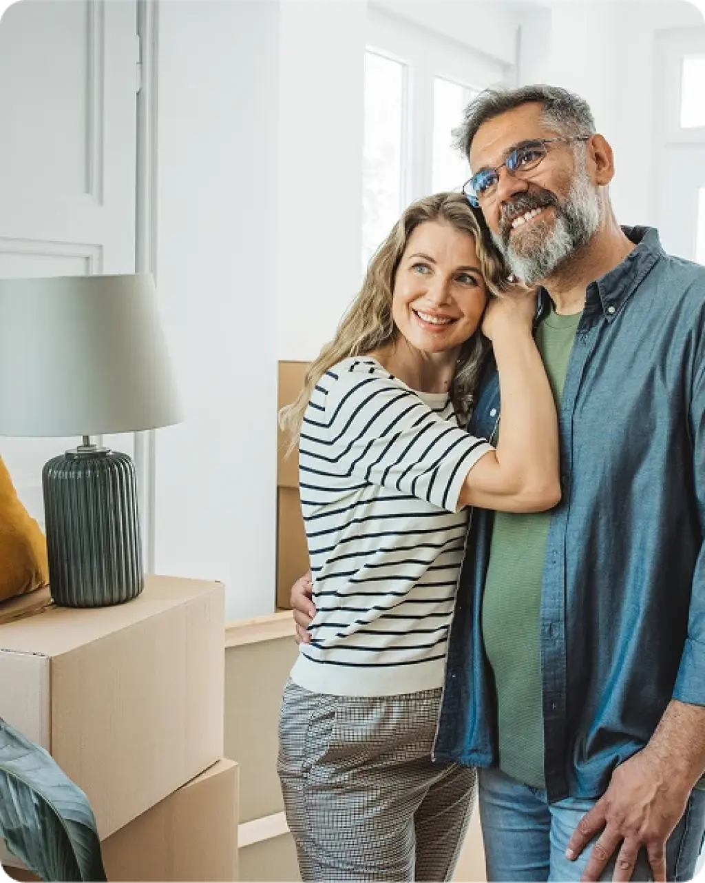 Couple in new home surrounded by moving boxes after relocation with Kent Removals & Storage