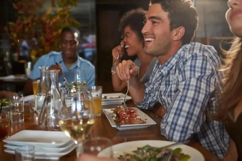 Friends enjoying dinner at restaurant table