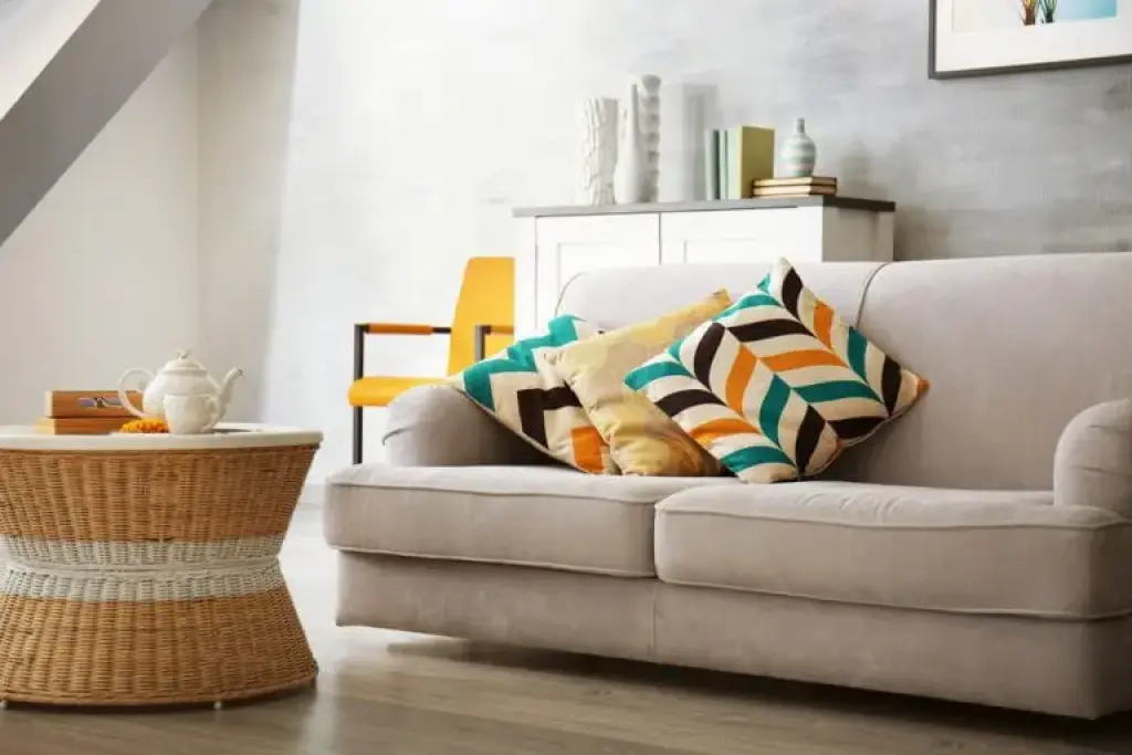 A sofa in the living room of the new home with a happy color pillow