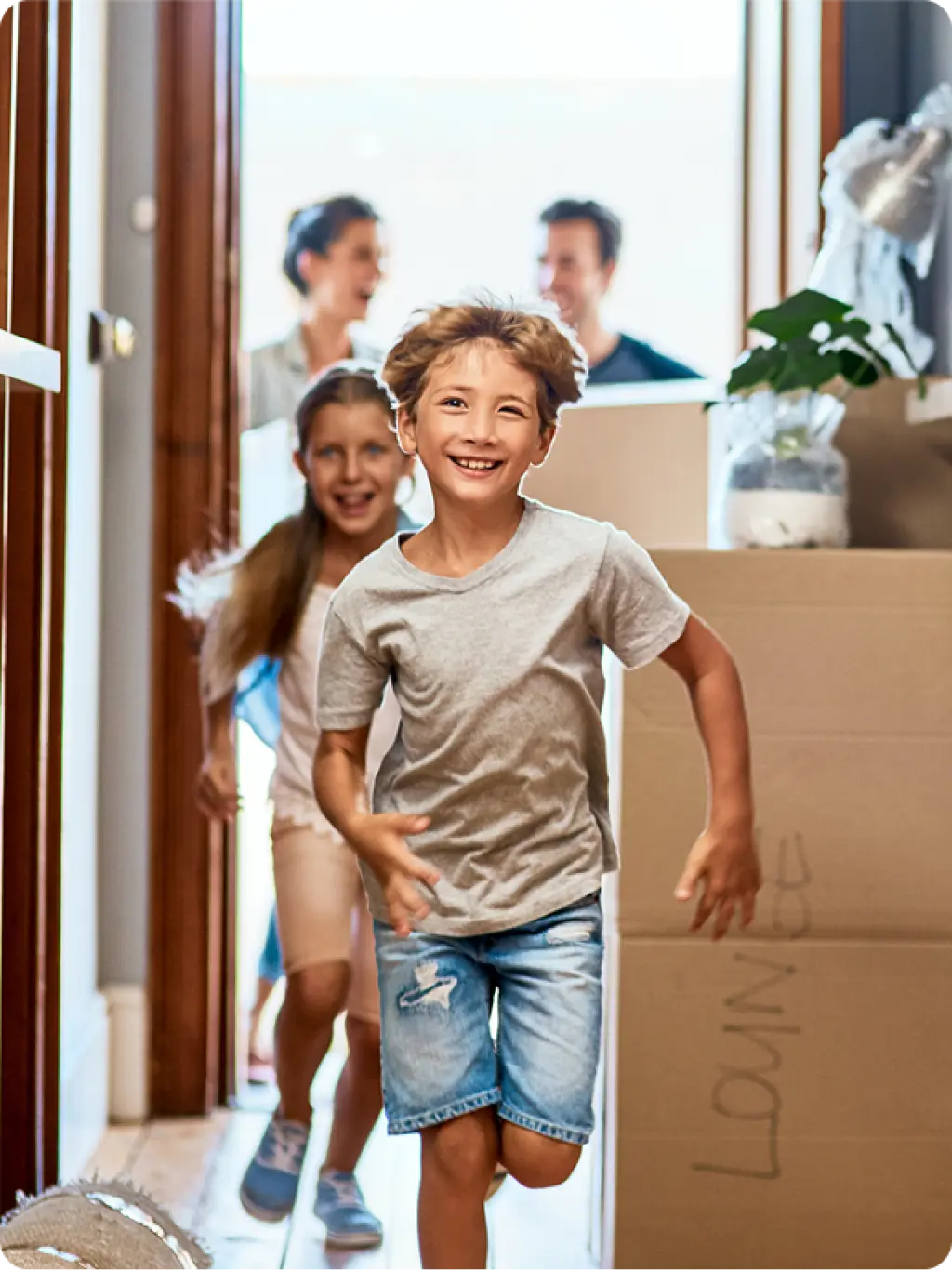 Children running excitedly into new home during family moving day