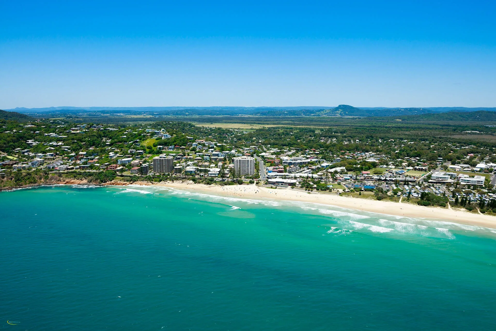 Aerial view of Coolum Beach coastline and township on Sunshine Coast