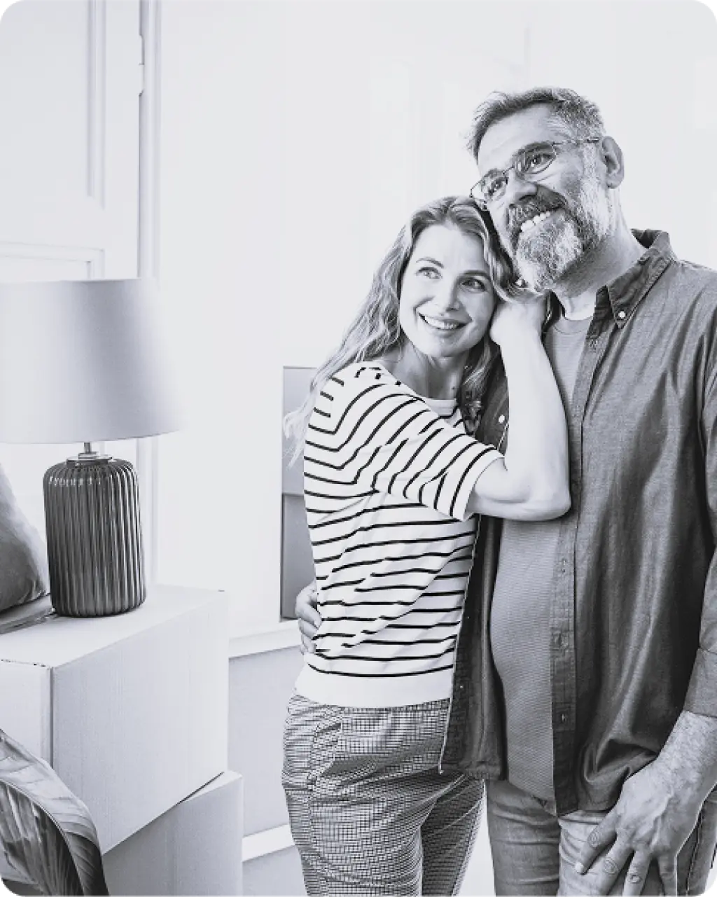 Couple in new home surrounded by moving boxes after relocation with Kent Removals & Storage