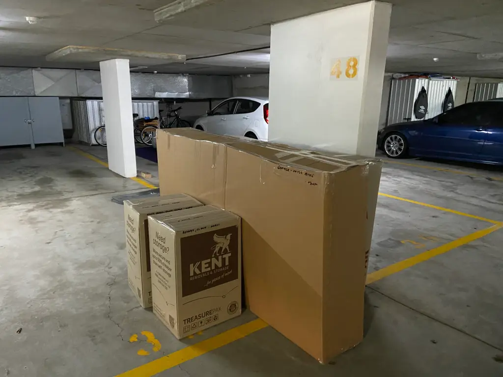 Packed Kent Removals moving boxes and furniture prepared in parking area