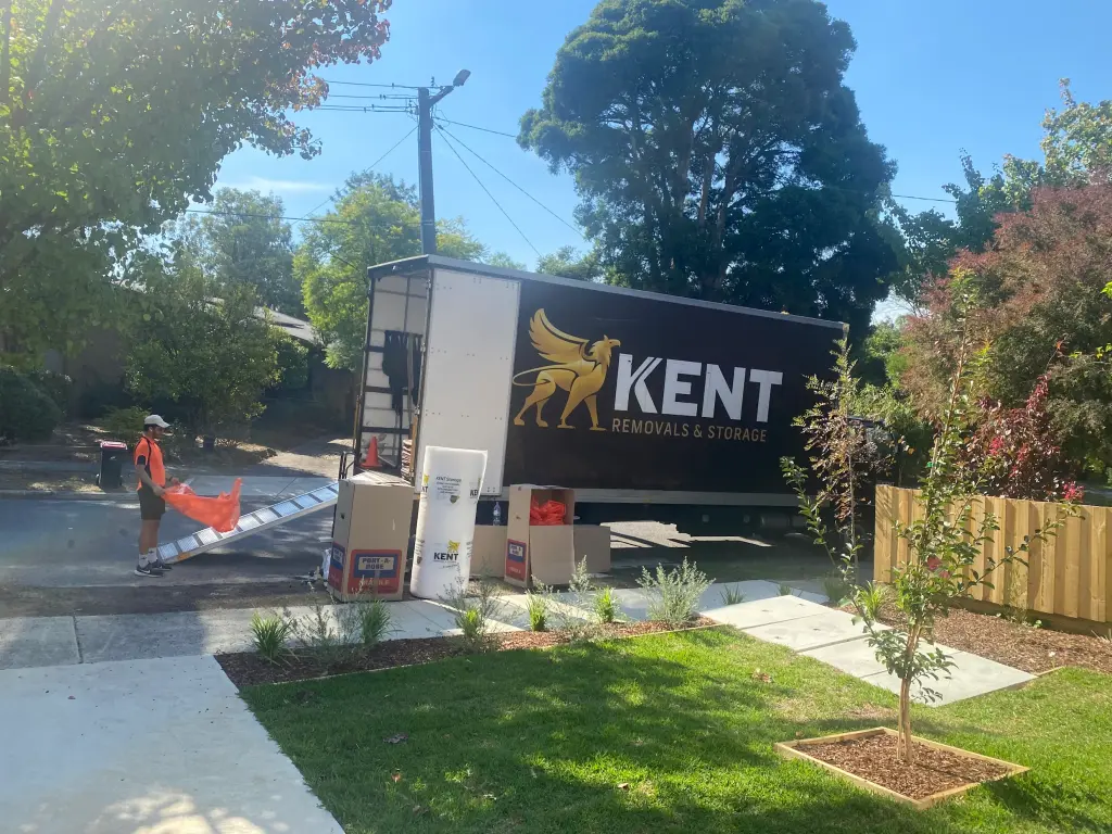 Kent Removals truck unloading moving boxes at residential property