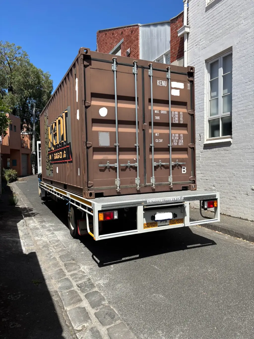Kent Removals storage container truck parked in residential street for relocation