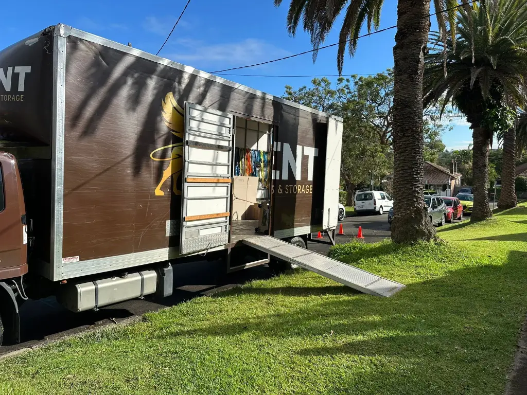 Kent Removals truck unloading household items on residential street